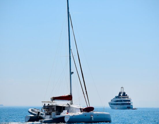 white boat on sea during daytime