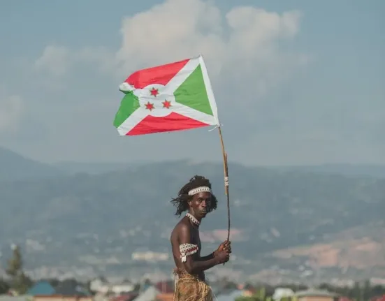 Man Holding a Flag of Burundi