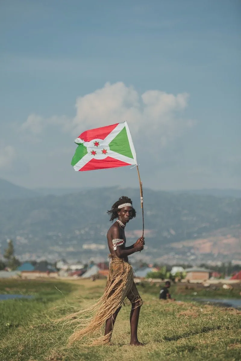 Man Holding a Flag of Burundi