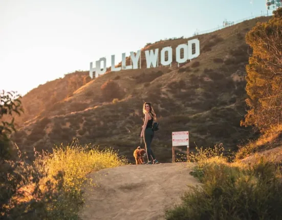 woman standing with brown dog