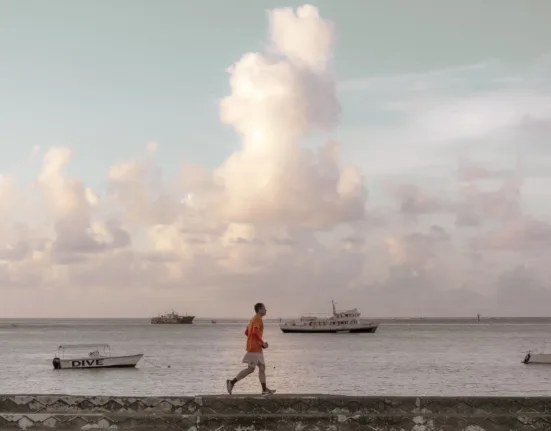 man walking on bay