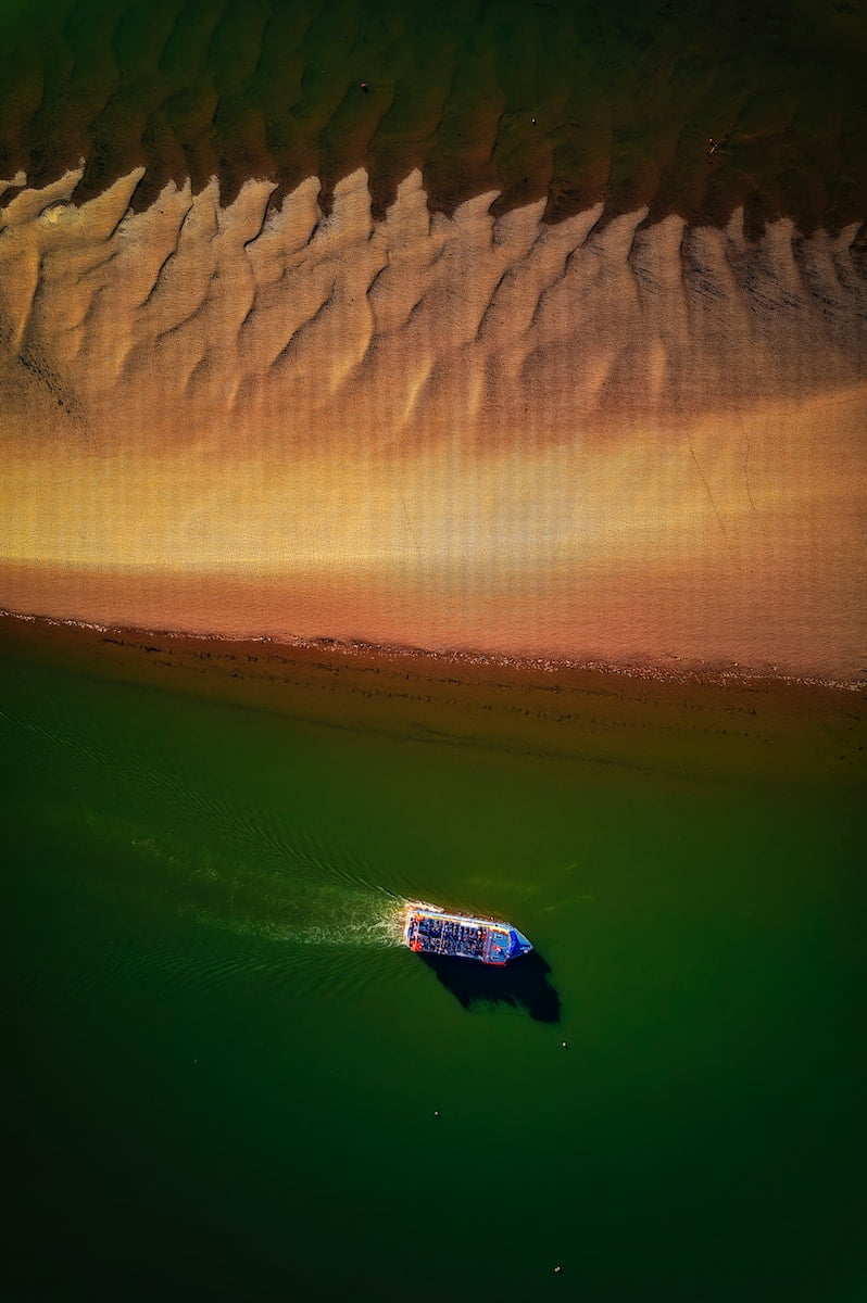 a boat floating on top of a body of water