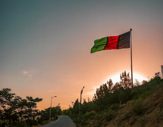 a flag is flying high in the sky
