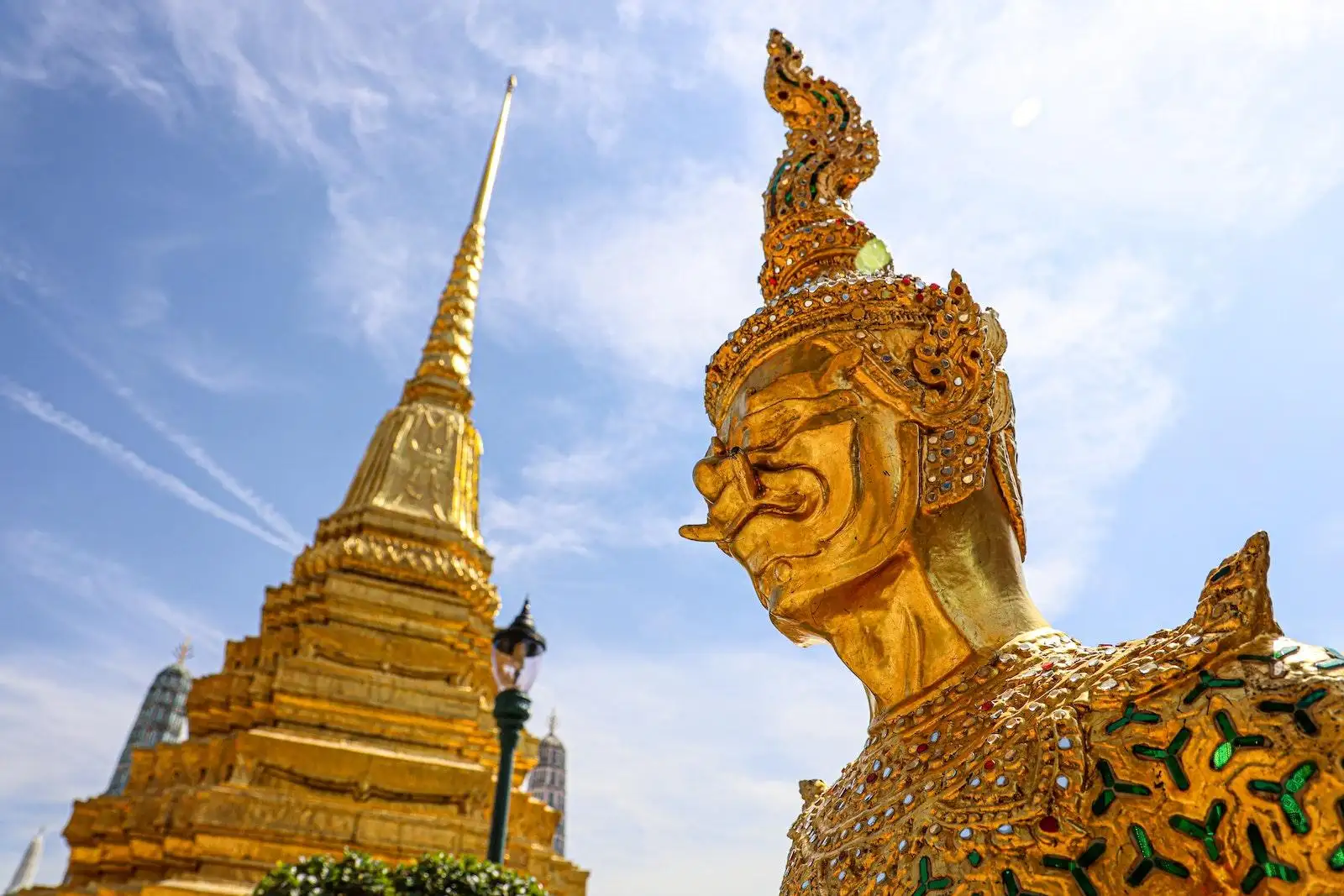 Photo by Tony Wu Gold Statue at the Temple of the Emerald Buddha in Bangkok