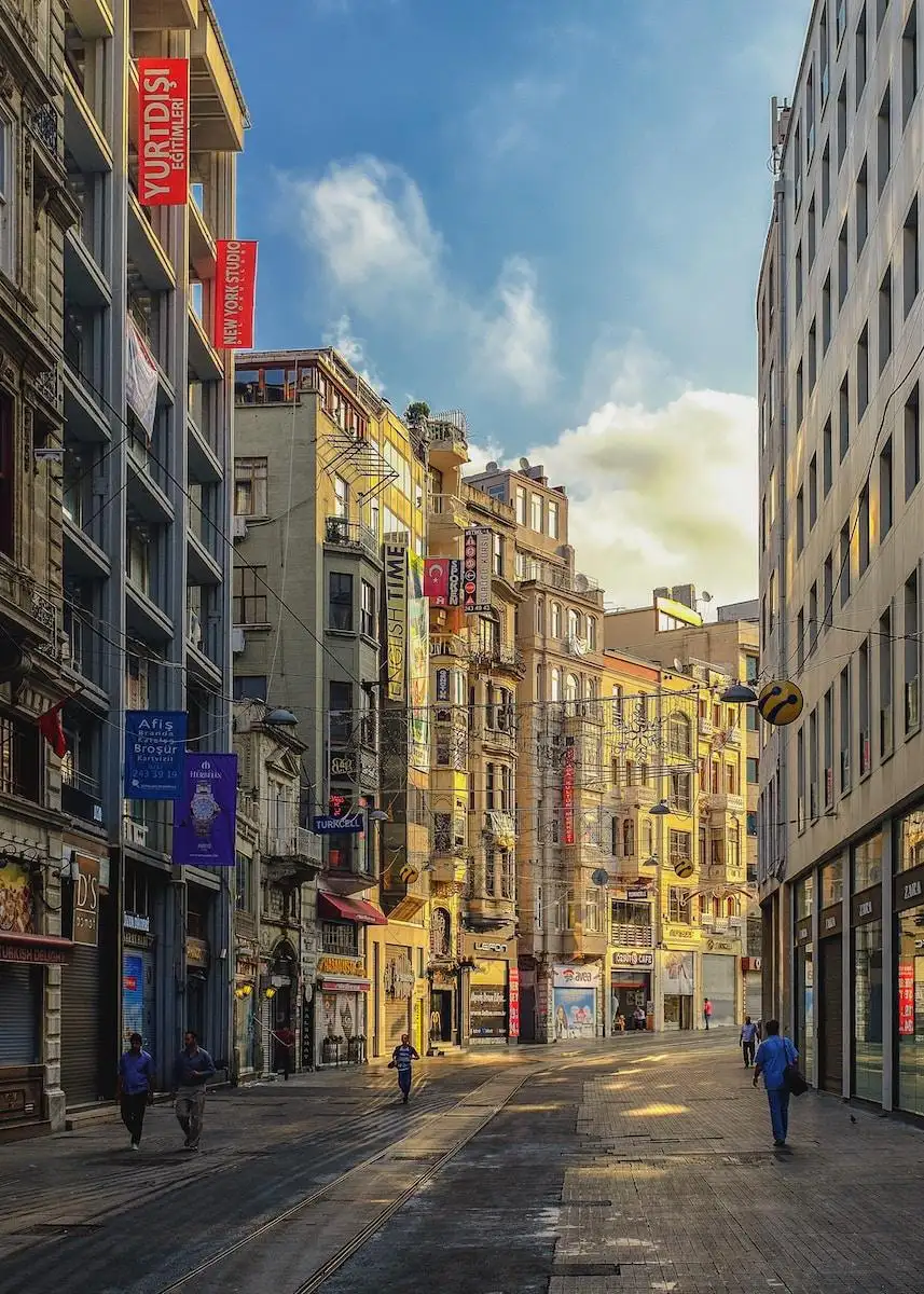 Photo by Drew McKechnie people walking on alley surrounded with buildings artwork