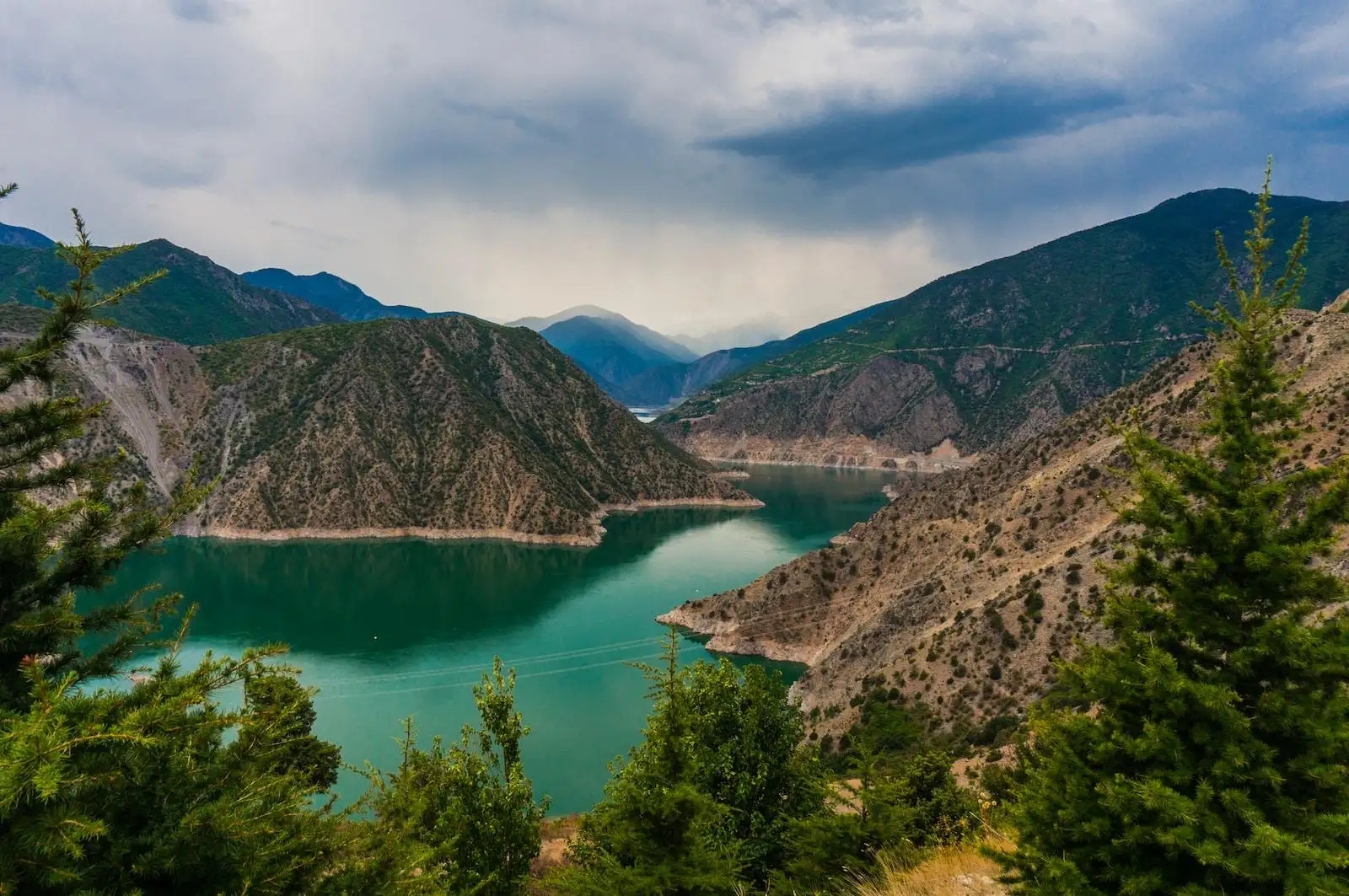 Photo by Huseyin Kaya photo of mountain and body of water