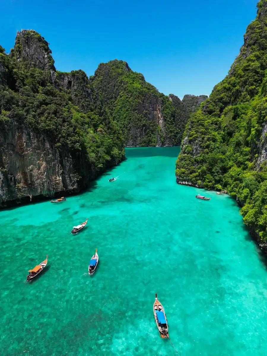 Photo by Yannick Apollon a group of boats floating on top of a body of water