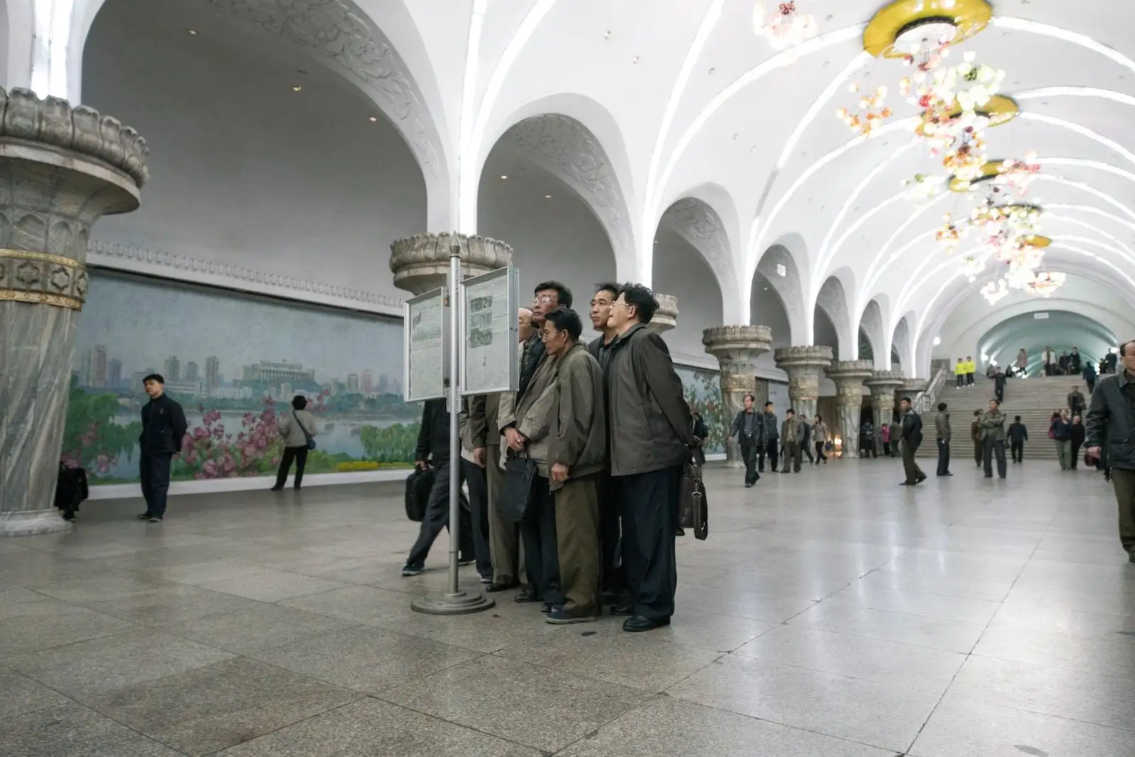 Photo by Random Institute group of men standing beside signage