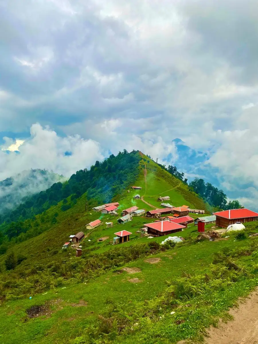 Photo by Amirreza Zarghami houses on green grass field under white clouds and blue sky during daytime