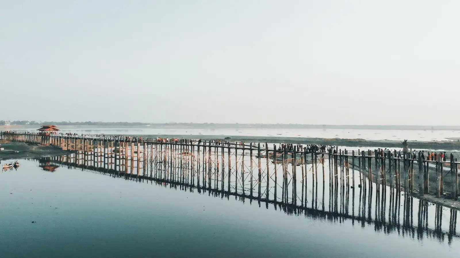 Photo by Anna Claire Schellenberg brown wooden dock on sea under white sky during daytime