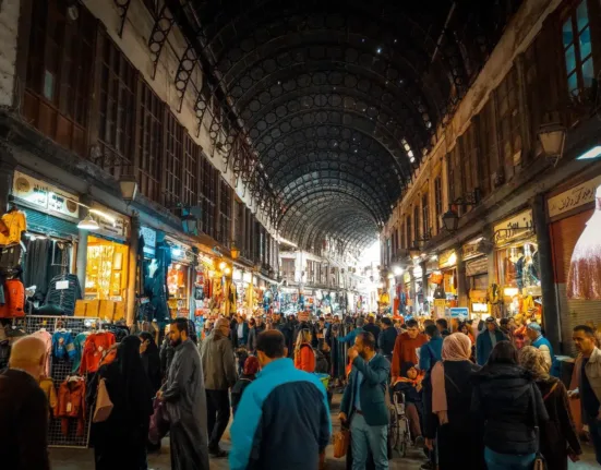 a large group of people walking through a market