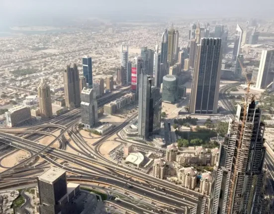 an aerial view of a city with train tracks