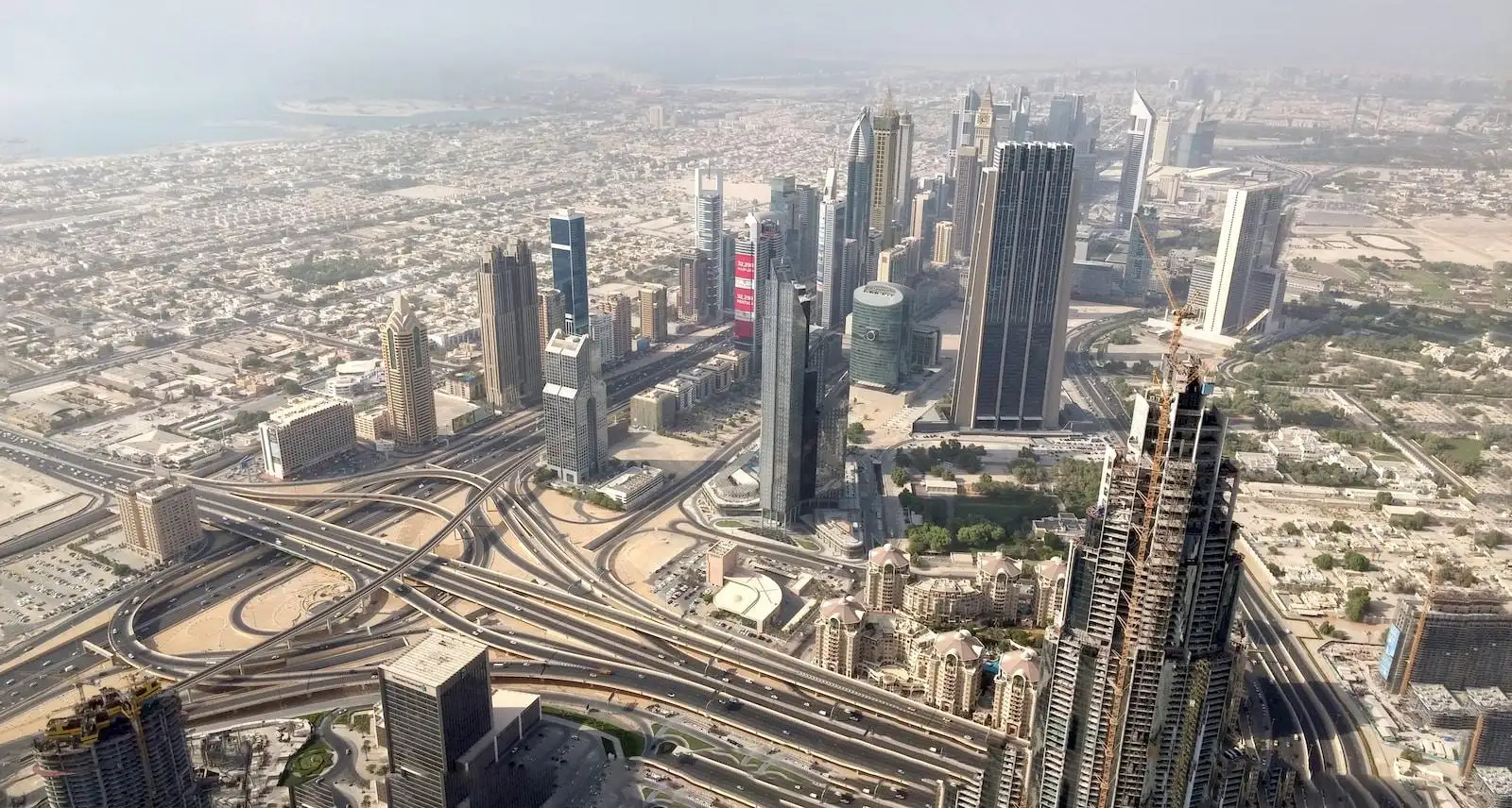 an aerial view of a city with train tracks