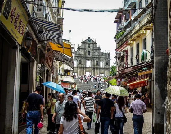 a group of people walking down a street with umbrellas