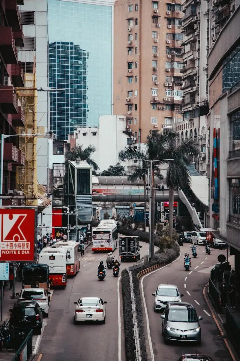 Photo by Roland Kwok a city street filled with lots of traffic next to tall buildings