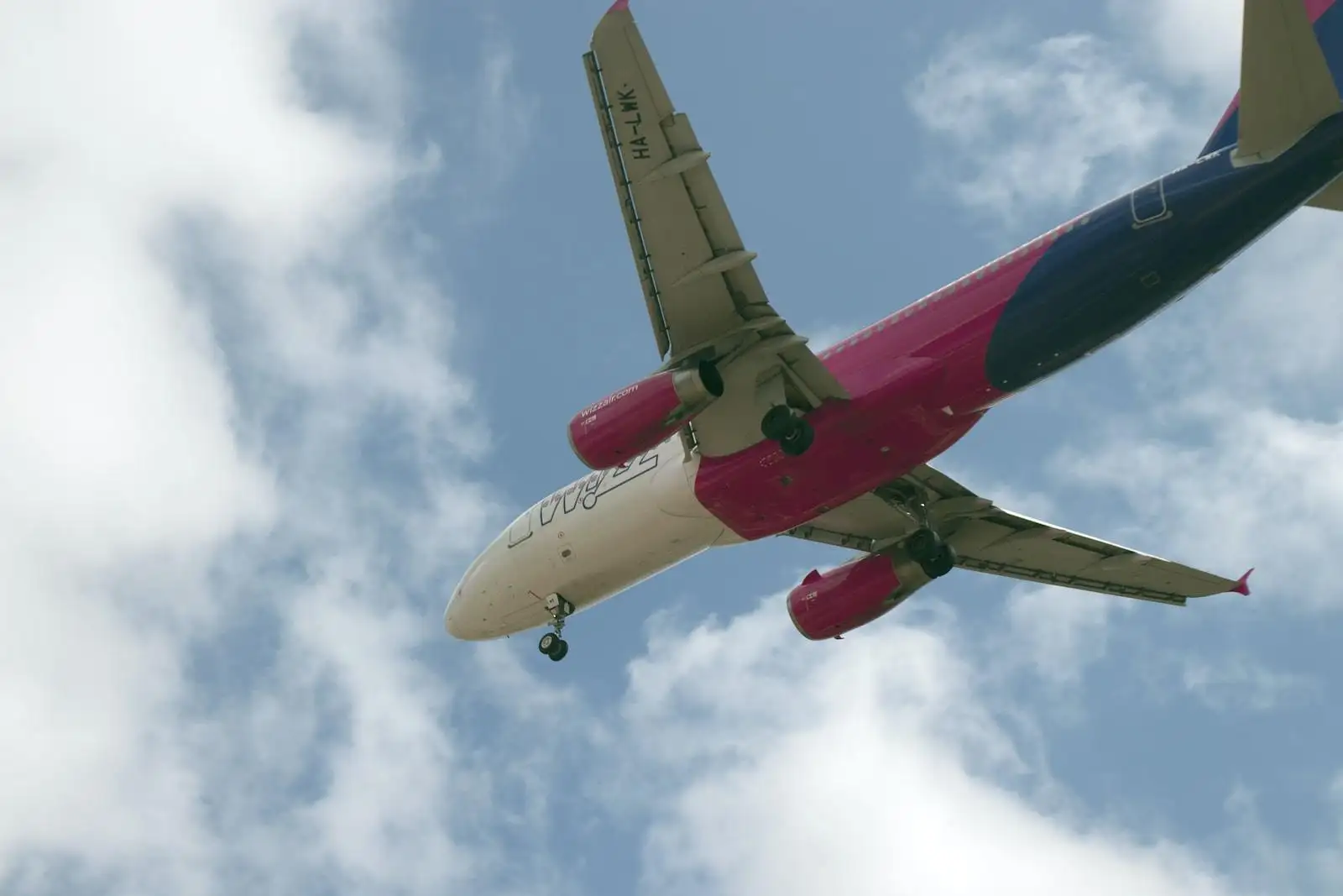 Photo by Álvaro Ibáñez white and red passenger plane flying in the sky during daytime