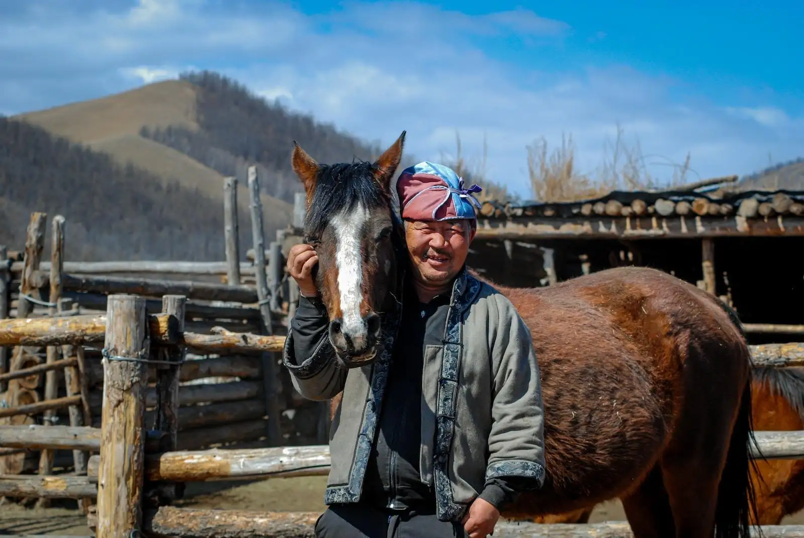 a man standing next to a brown horse