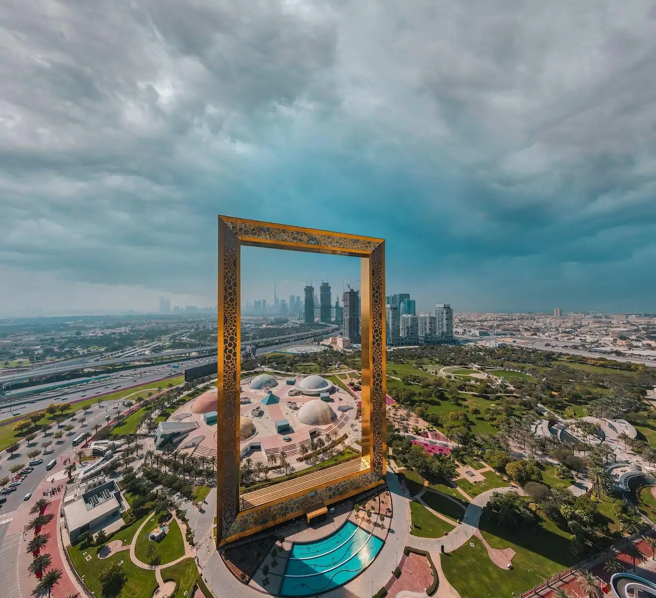 Photo by Ahmed Aldaie brown wooden framed mirror on top of a building