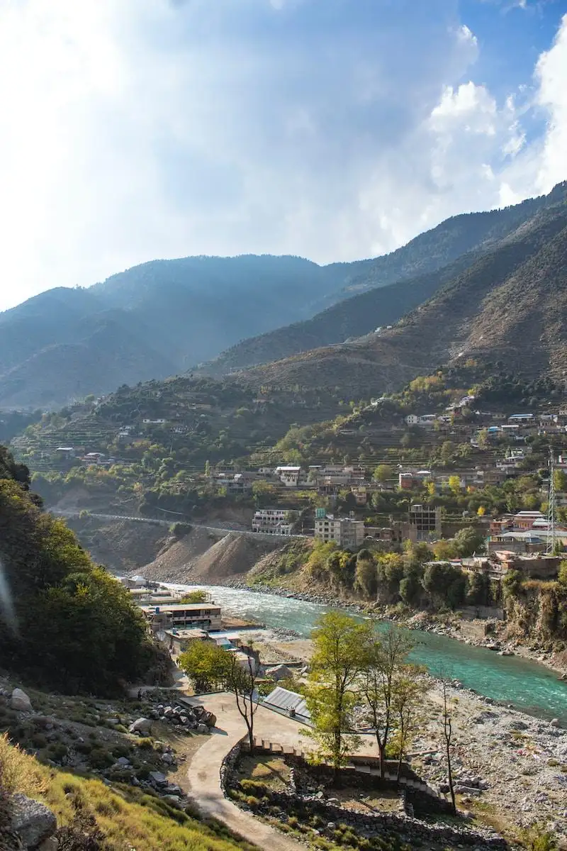 Photo by Ahmed Yanaal body of water near mountains under white clouds