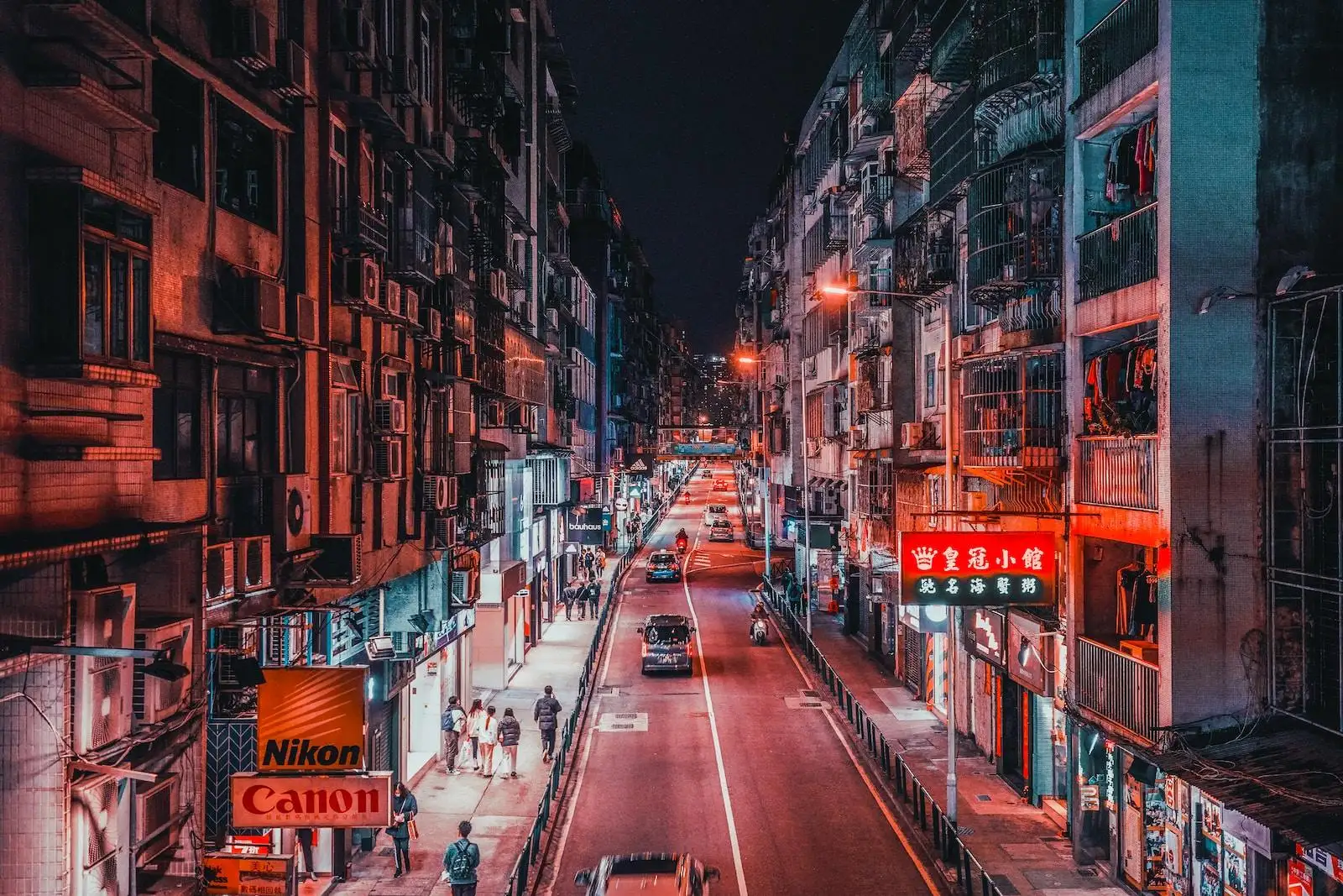 Photo by Dynamic Wang a city street filled with lots of tall buildings