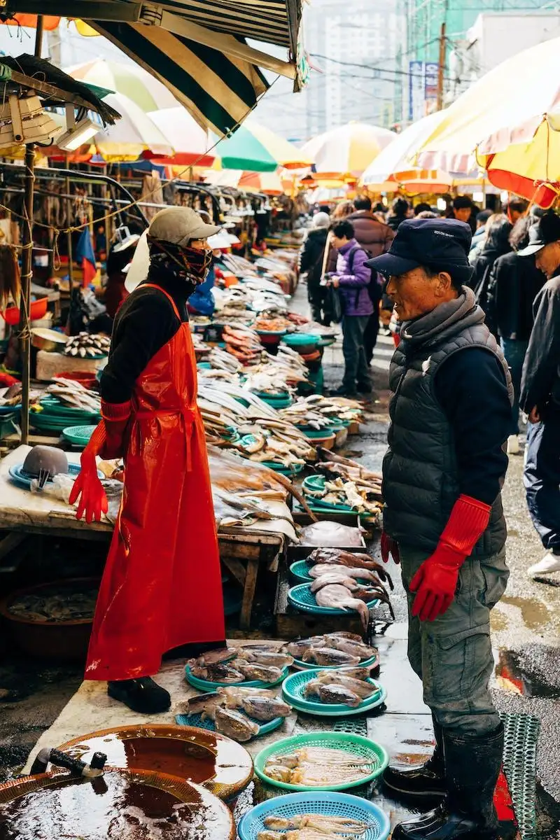 Photo by Markus Winkler A Crowd Of People In The Fish Market Lined With Colorful Umbrellas
