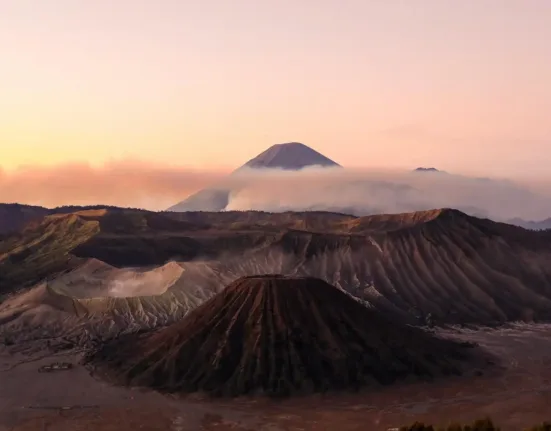 silhouette photo volcanoes during golden hour