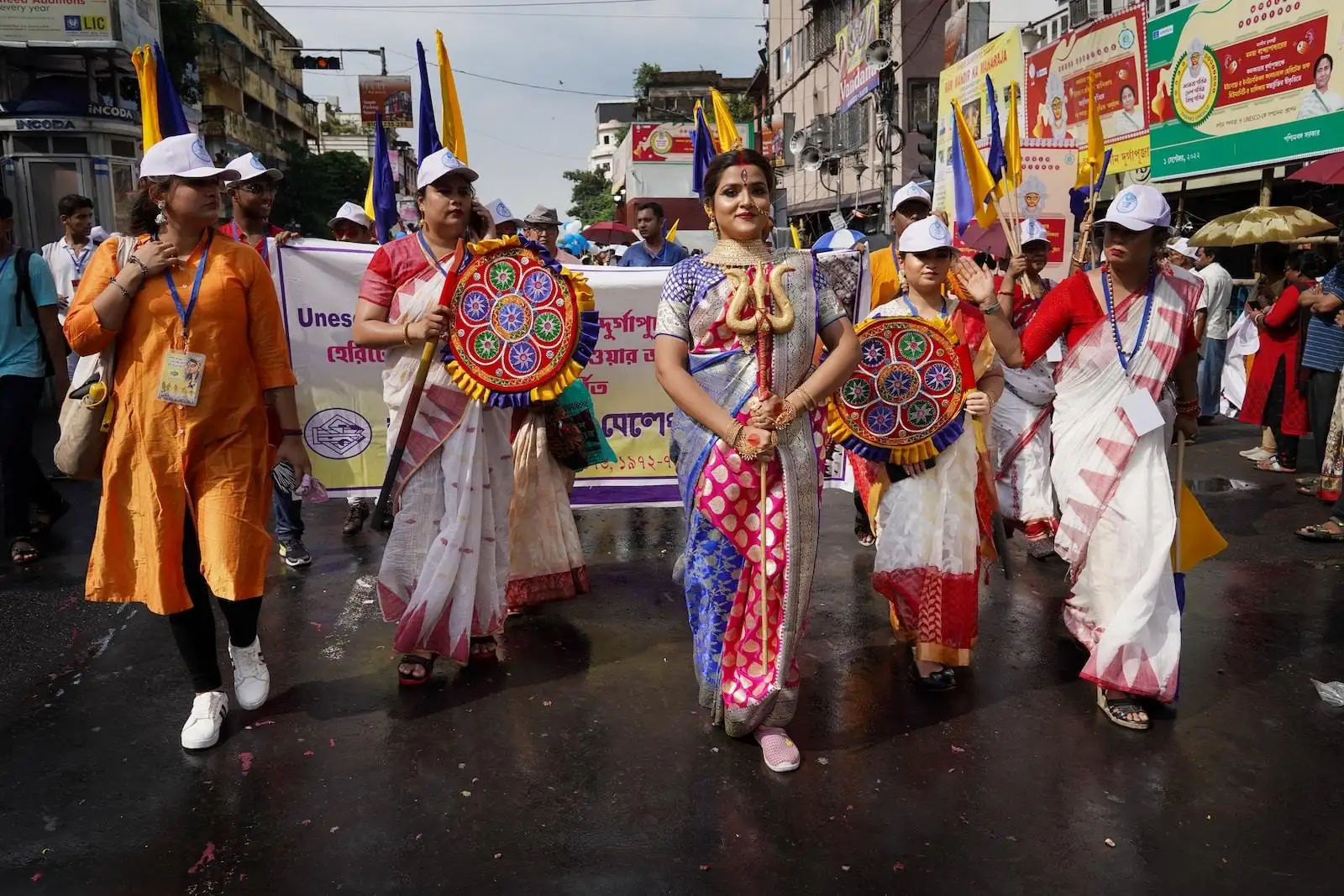 a group of people walking down a street holding flags
