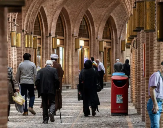 a group of people walking down a brick walkway