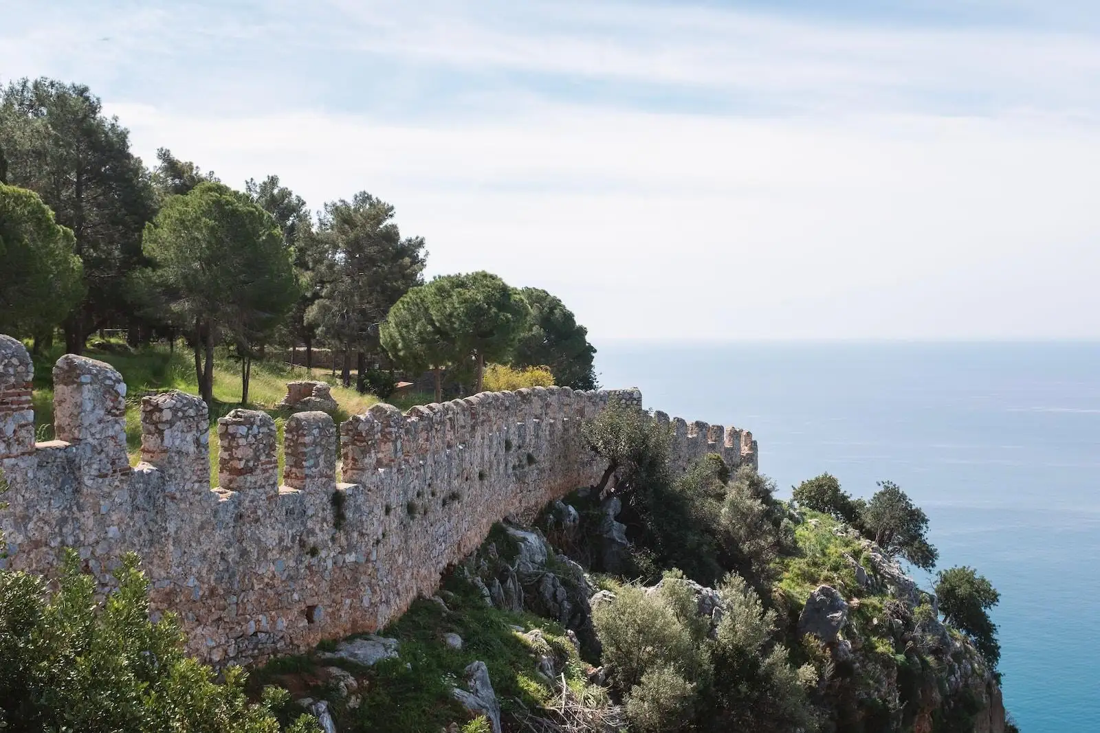 Photo by Arthur Shuraev a stone wall on the side of a cliff