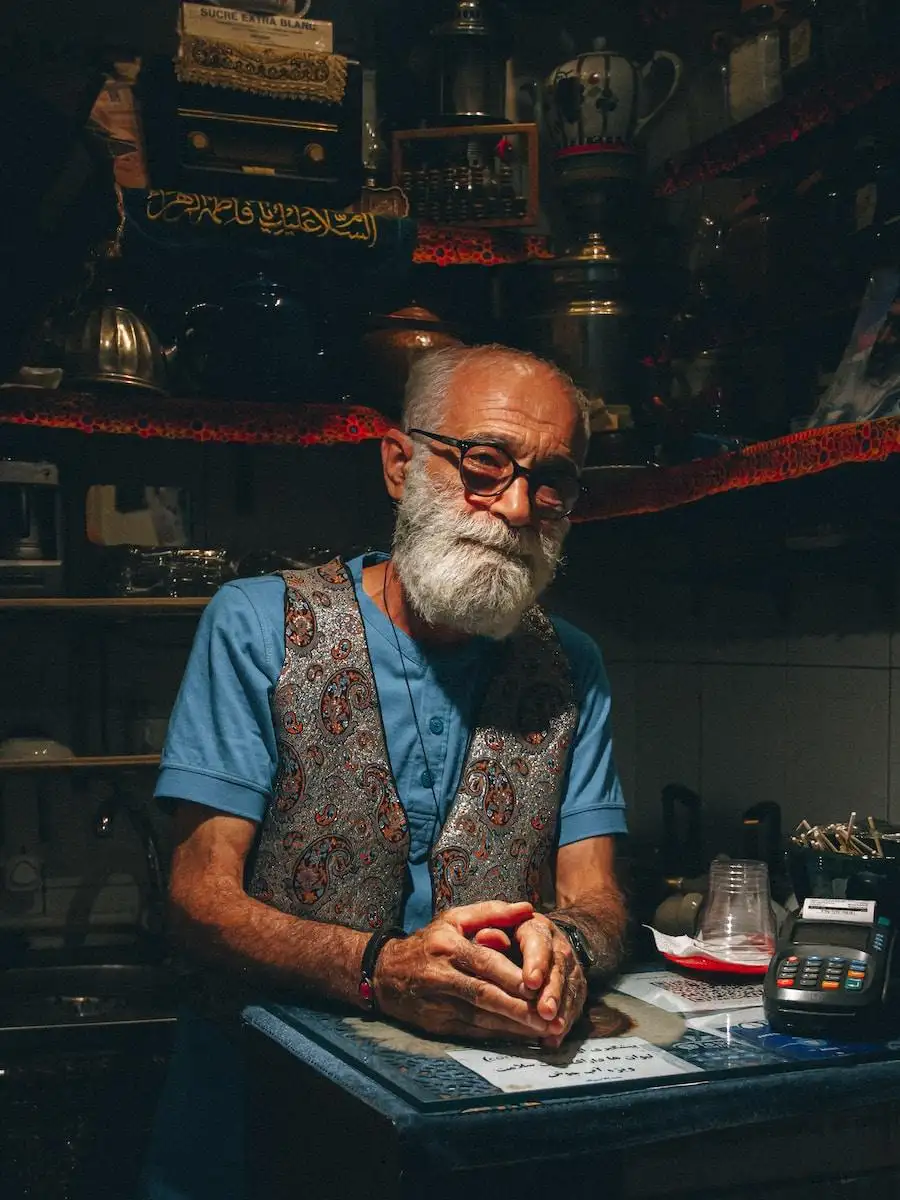 Photo by Khashayar Kouchpeydeh man in blue and white floral button up shirt wearing eyeglasses