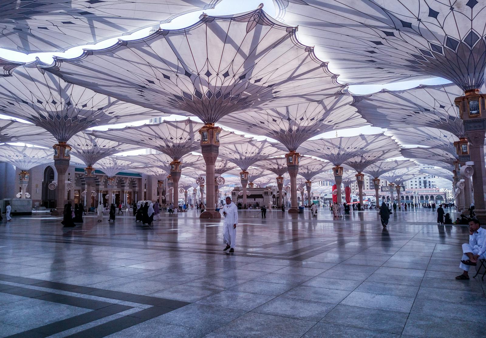 People Walking on White and Gray Tiled Floor