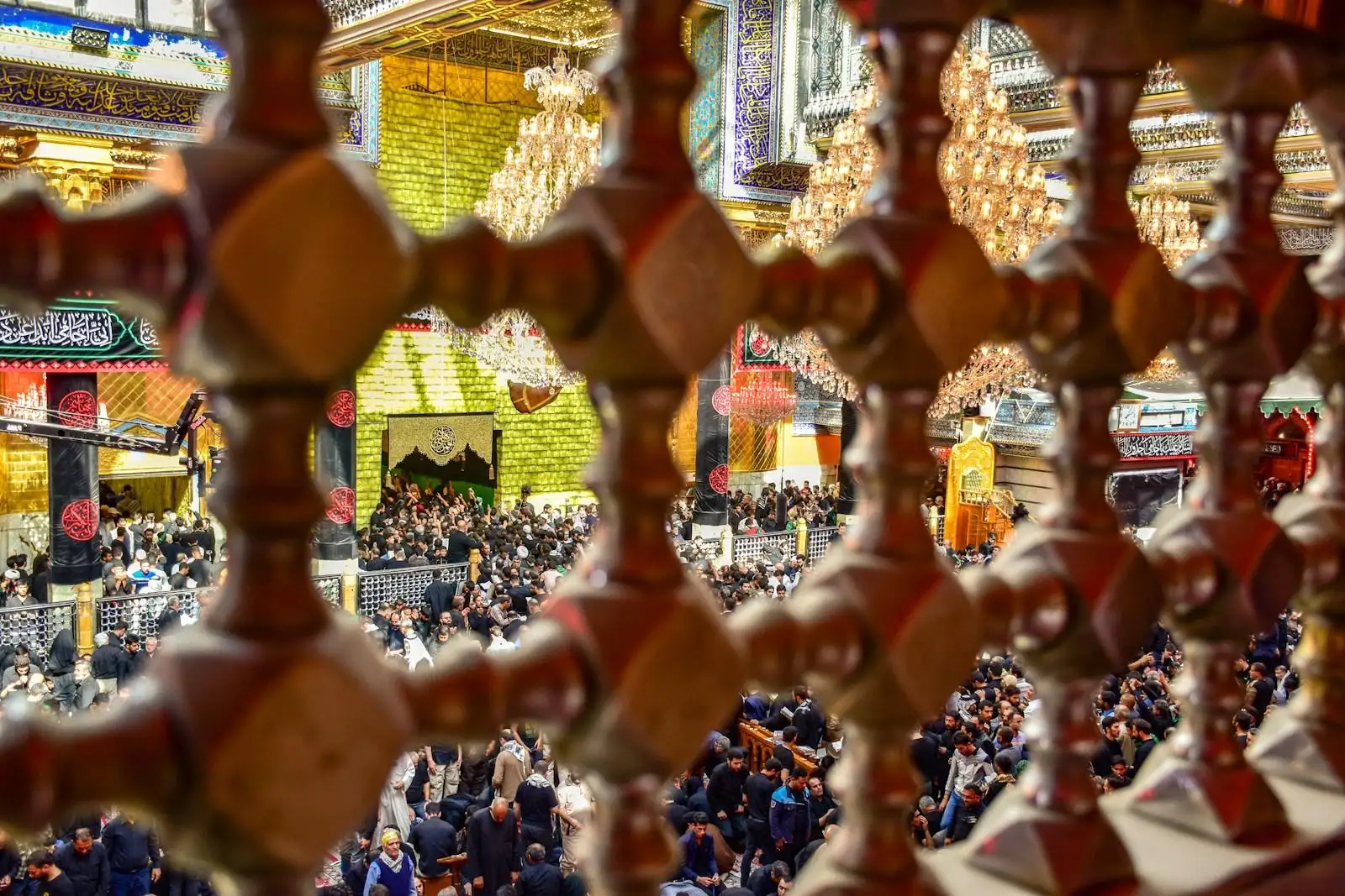 Photo by أخٌفيالله people gathering inside building with big chandeliers