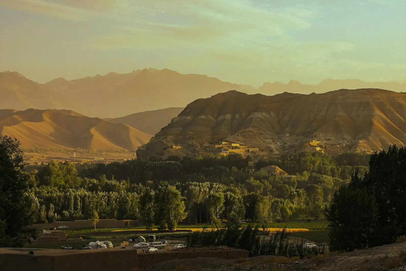 Photo by Zabihullah Habibi a scenic view of a valley with mountains in the background