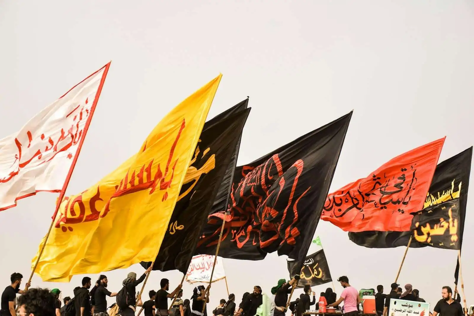 Photo by أخٌفيالله people holding assorted flags