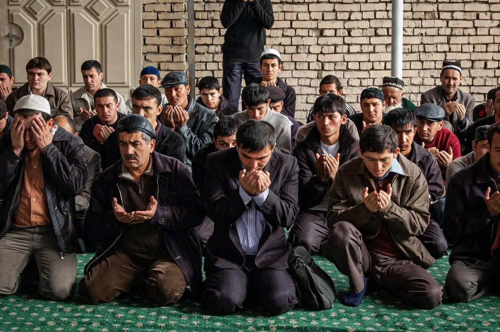 Photo by Joel Heard group of men sitting on green floor